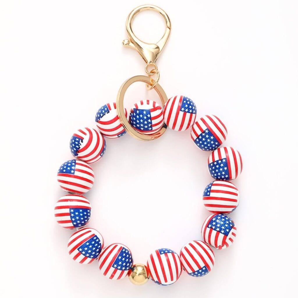 Wood keychains with round beads featuring the American flag design and a gold clasp, arranged in a circular shape against a white background.