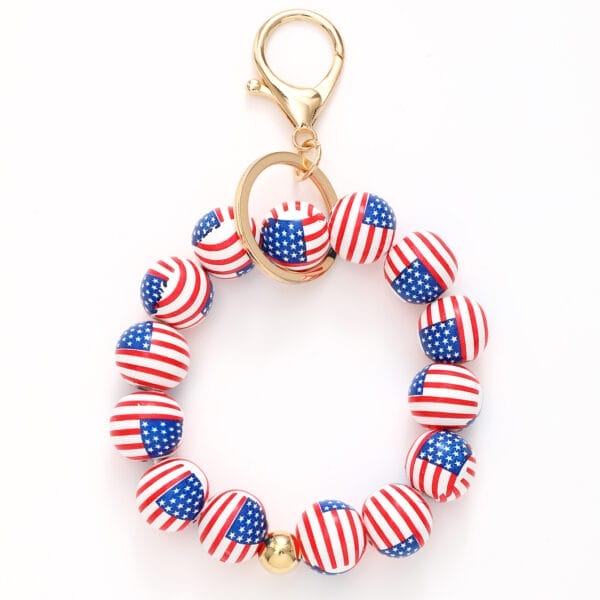 Wood keychains with round beads featuring the American flag design and a gold clasp, arranged in a circular shape against a white background.