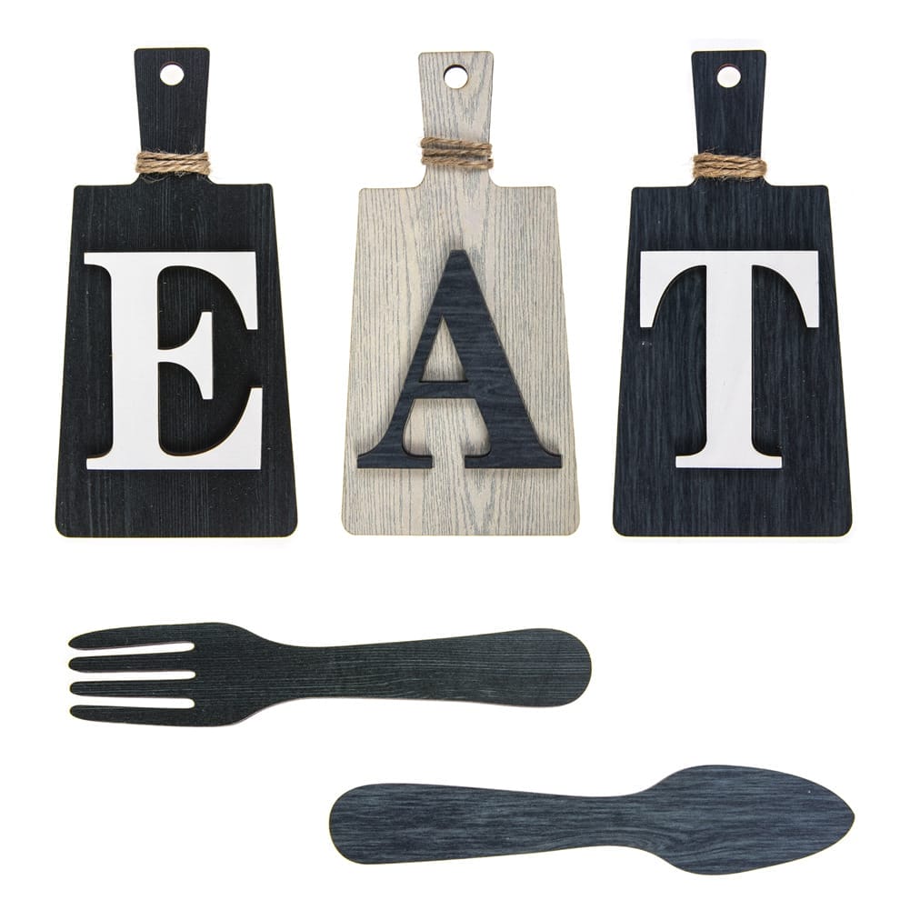 Three cutting boards with the EAT letter logo are arranged above black wooden cutouts of a fork & spoon set.