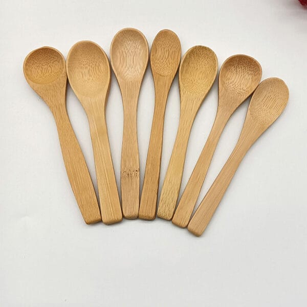 Set of eight small bamboo spoons, ideal for wholesale or distribution by a wooden spoon manufacturer.