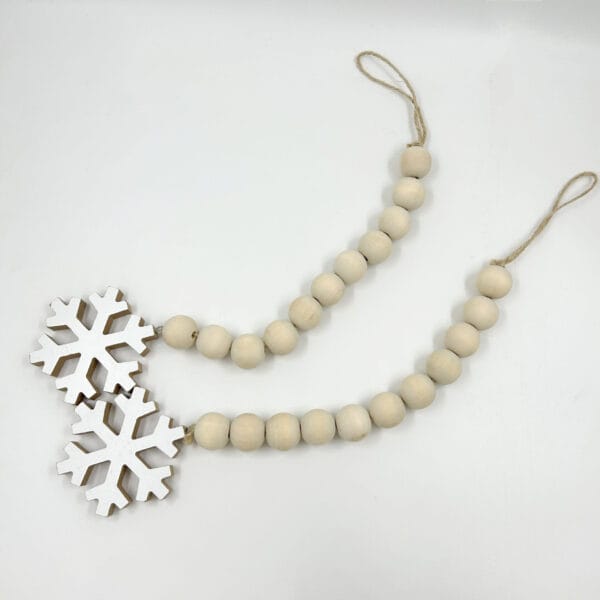 Wooden bead garland with snowflake accents. Wholesale hanging decoration.