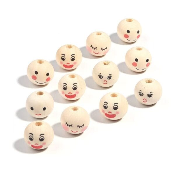 Twelve round wooden beads with painted faces showing different facial expressions, arranged in rows on a white background.