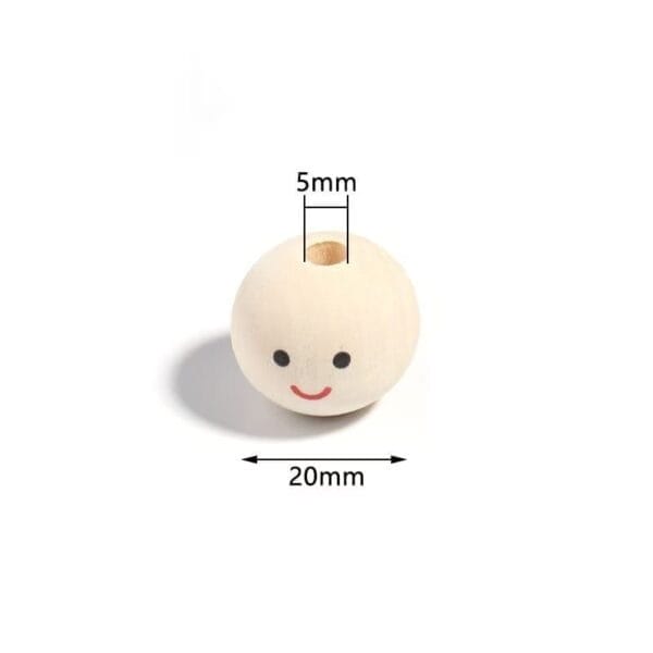 Wooden bead with a smiling face, 20mm in diameter and a 5mm hole through the center, placed on a white background.