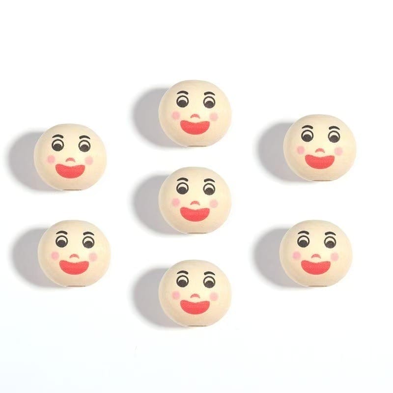 Seven round objects with identical cartoon faces, featuring wide eyes, red lips, and rosy cheeks, arranged in a grid pattern on a white background.