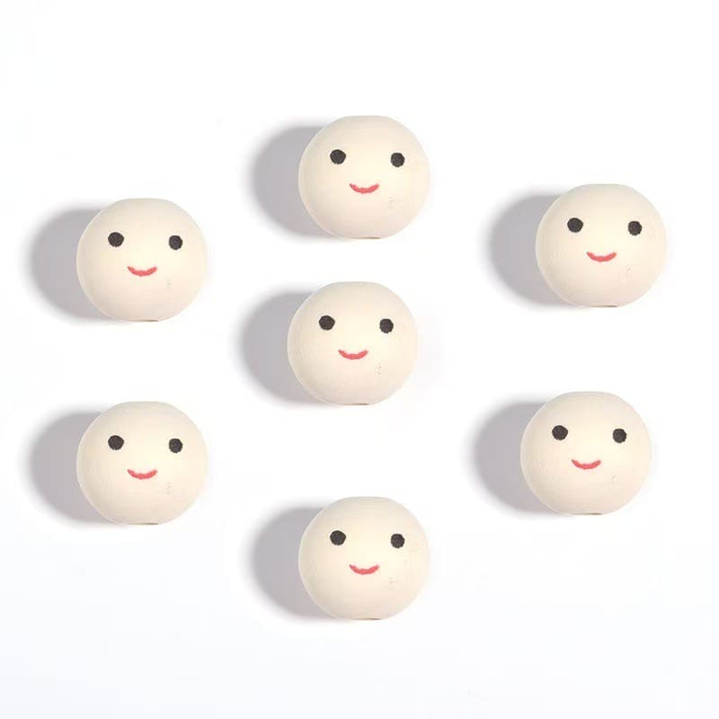 Seven round white objects with simple black eyes and red smiling mouths are arranged in a grid pattern on a white background.
