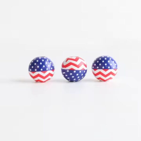 Three patriotic balls with red and blue star patterns.