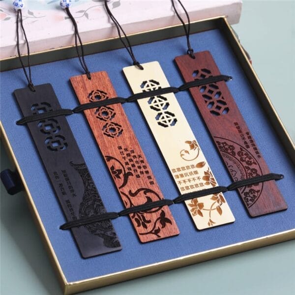 A set of five Chinese style wooden bookmarks with intricate cutout and laser engraved designs, displayed in a blue-lined box with black elastic bands—perfect from a quality bookmarks manufacturer and ideal as laser engraved gifts.