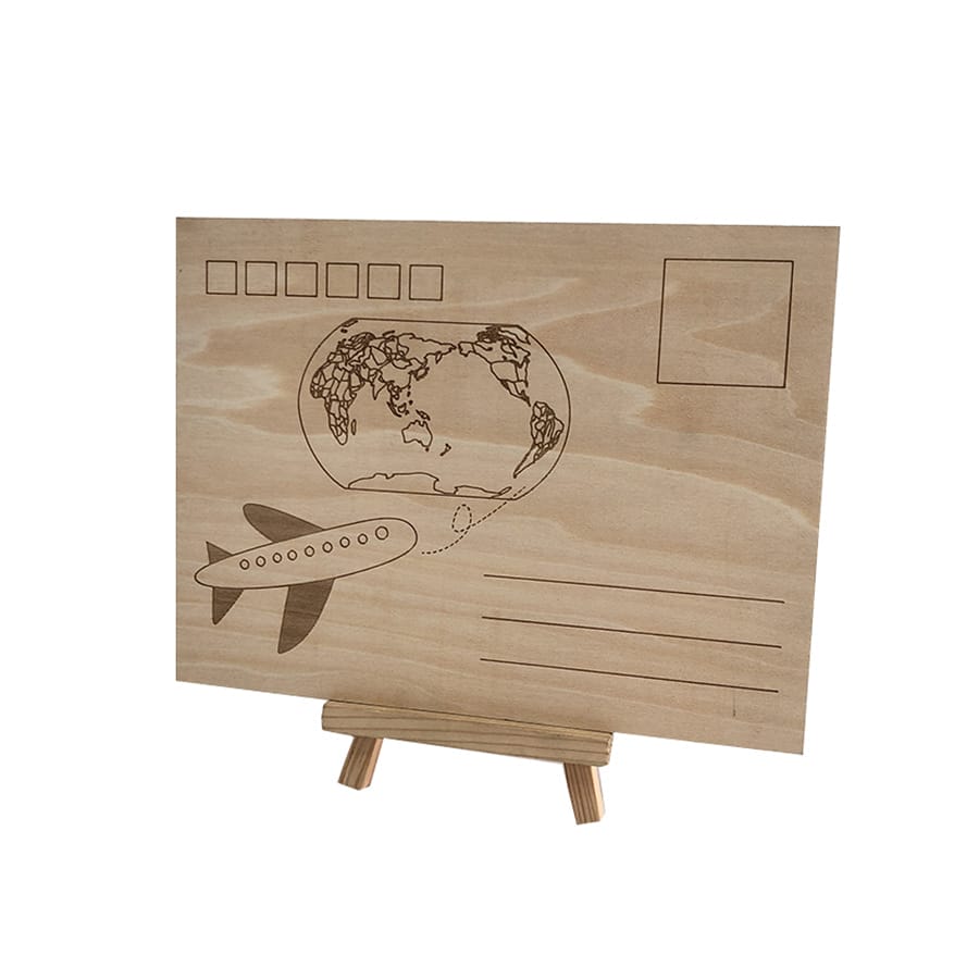 A wooden postcard featuring an engraved airplane, a map of the world, a stamp box, and lines for an address, displayed on a small wooden easel—perfect as a unique Wooden Business Card for commercial events.