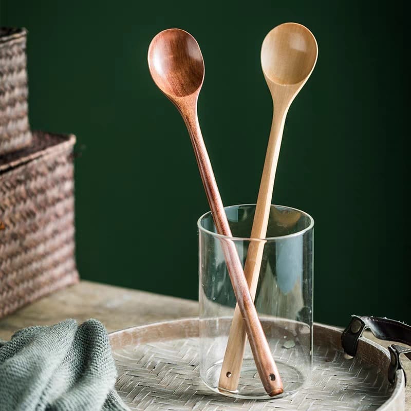 Two wooden cooking spoons in a glass, wholesale wooden spoon supplier.
