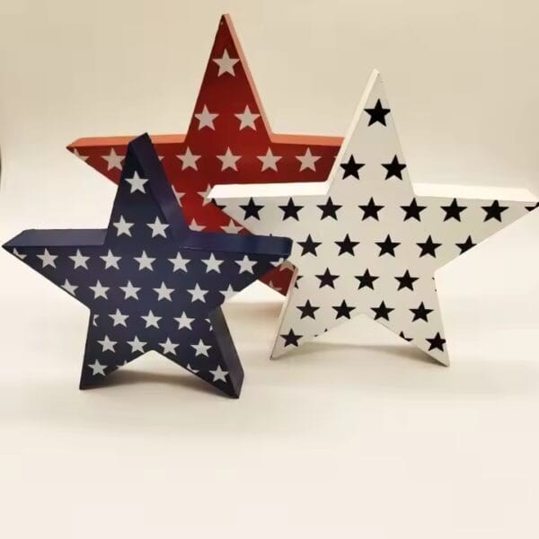 Three patriotic wooden stars, red, white, and blue, decorated with smaller stars. Custom wooden crafts.