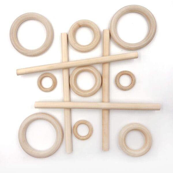 Wooden curtain rings and rods arranged in a tic-tac-toe grid pattern on a white background, highlighting an eco-friendly touch.
