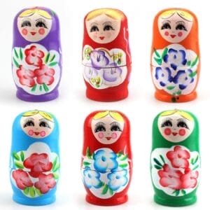 Six colorful wooden Russian nesting dolls, each painted with floral patterns and smiling faces, arranged in two rows of three against a white background—a charming example of traditional wooden giftware.