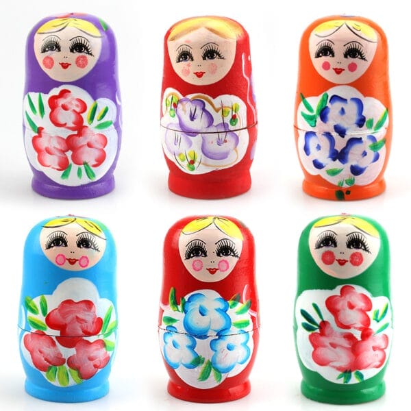 Six colorful wooden Russian nesting dolls, each painted with floral patterns and smiling faces, arranged in two rows of three against a white background—a charming example of traditional wooden giftware.