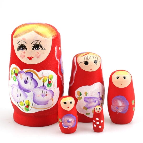 Five Matryoshka dolls in varying sizes, hand-painted red with floral designs and faces, are arranged in a row against a white background.