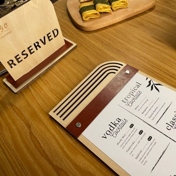 Wooden menu board with "Reserved" sign and drink menu featuring cocktails. Eco-friendly design with replaceable inserts.