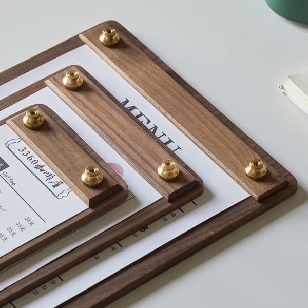 Freestanding walnut wood menu holder with brass accents. Displays "MENU" and pricing.