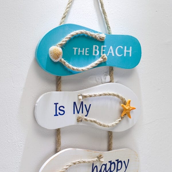Three wooden flip-flop signs hang vertically; the top is blue with "THE BEACH," the middle is white with "Is My," and each features a rope strap and shell or starfish, perfect as Mediterranean vintage wall decor or beach wall decor.