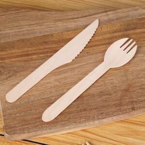 Wooden spoon and knife on a wooden board. Wholesale ice cream utensils.