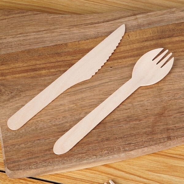 Wooden spoon and knife on a wooden board. Wholesale ice cream utensils.