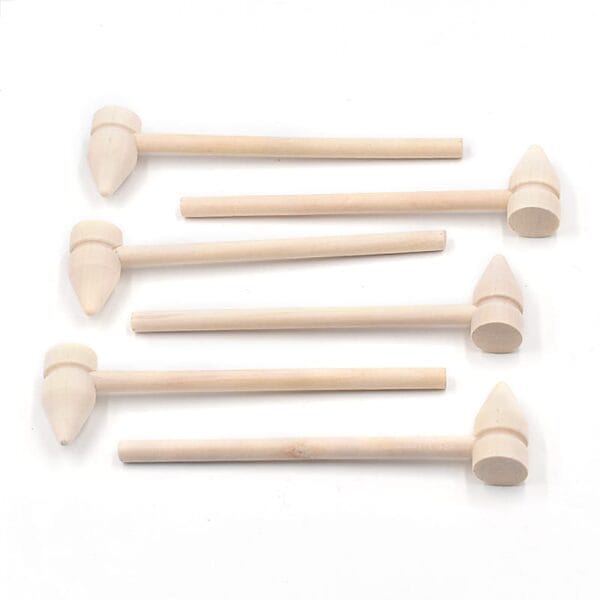 Five small mini wooden hammer toys with cylindrical handles and cone-shaped heads are arranged in a neat row on a white background—perfect for Wooden Sticks Crafts or available for wholesale orders.