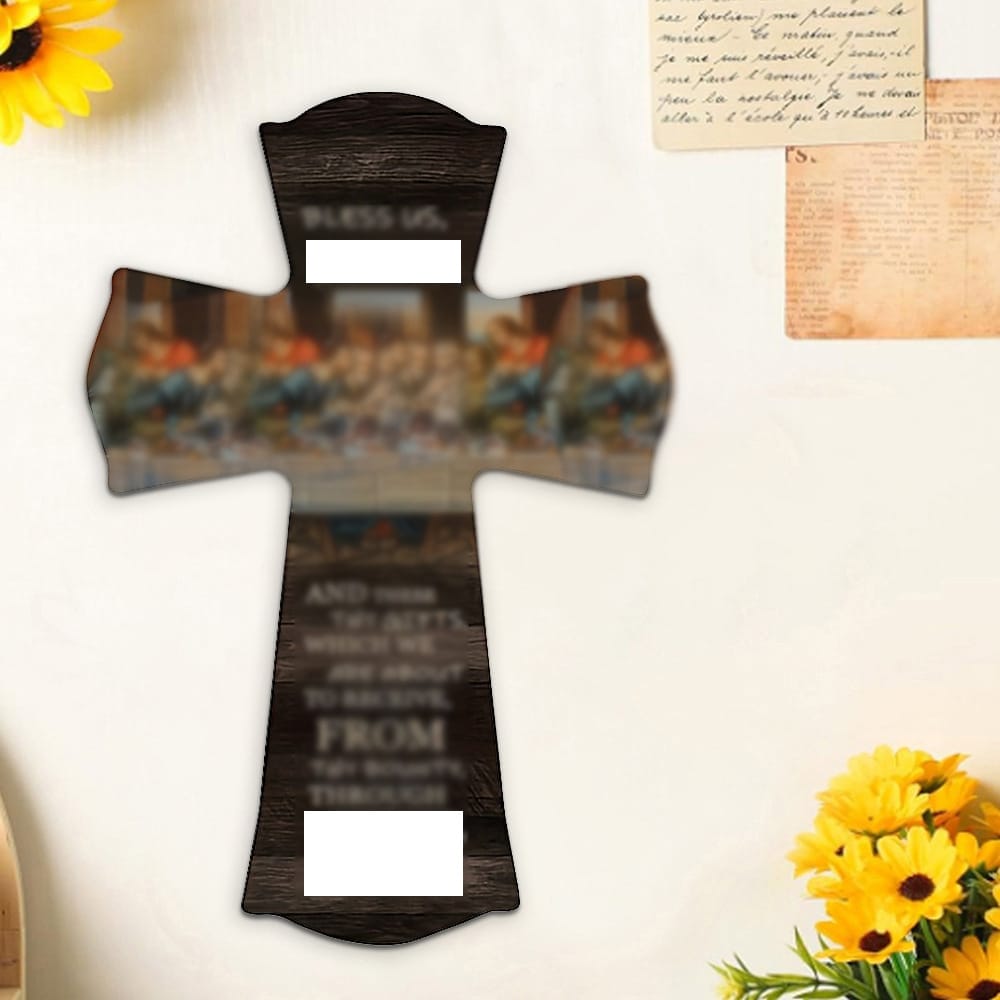 A wooden cross with an image of the Last Supper and inscriptions hangs on a wall beside yellow flowers, handwritten notes, and a small yellow cross decoration—an elegant example of eco-friendly wooden wall crosses.