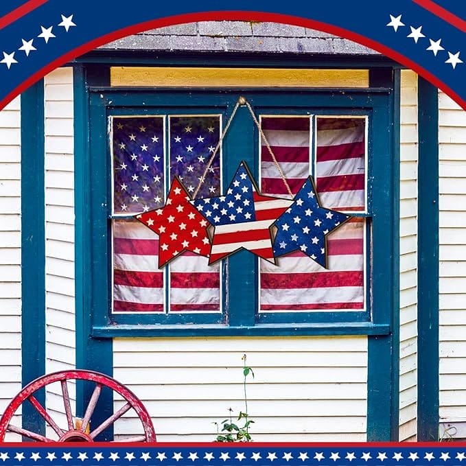 Patriotic wooden stars hanging on a window with American flags. Wooden yard signs.