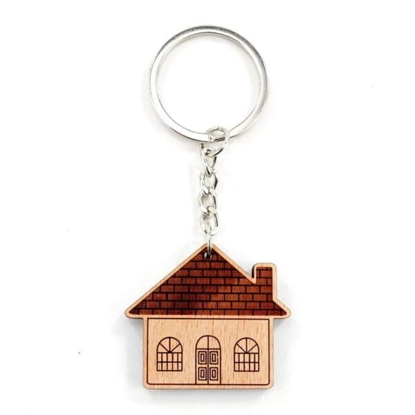 Personalised wooden keychain featuring laser-engraved house design with metal ring.