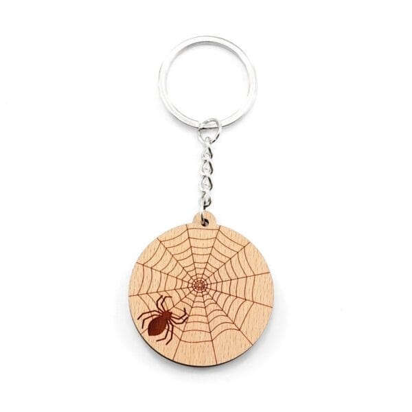 Personalised wooden keychain featuring a laser-engraved spiderweb and spider design, attached to a metal ring.