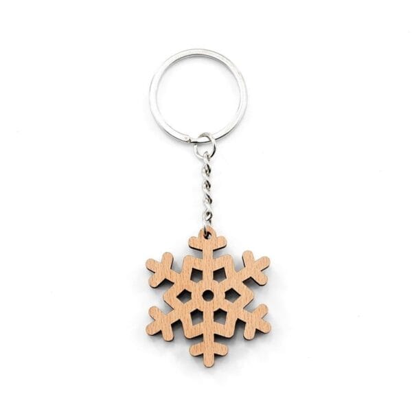 Personalised wooden keychain with laser-engraved snowflake design and metal ring.
