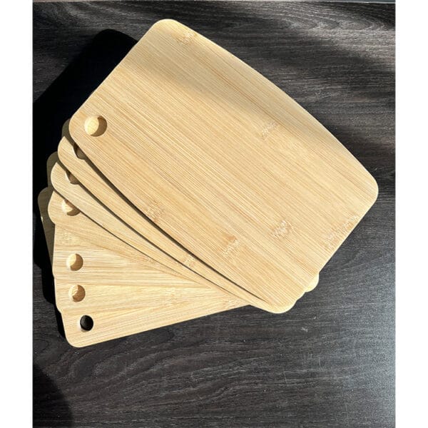 Stack of four bamboo chopping board. Customizable wooden cutting boards.