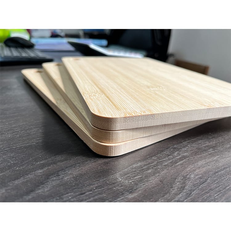 Two stacked bamboo chopping boards, ideal for kitchen use. Customizable wooden cutting boards available.