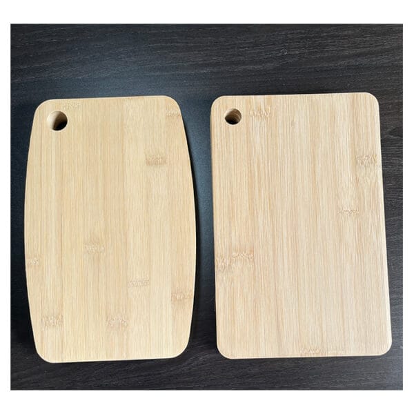 Two bamboo cutting boards; one rectangular, one curved. Custom wooden cutting boards.