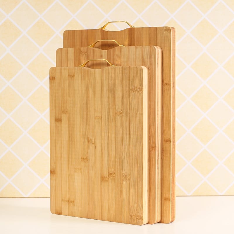 Three bamboo cutting boards with gold handles, ideal for wholesale.