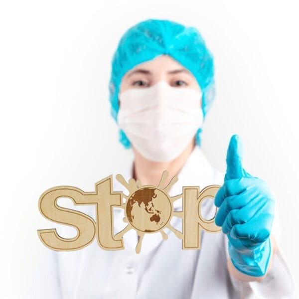 Doctor giving thumbs up with a custom wood "Stop" sign featuring a world map. Custom hanging plaque.