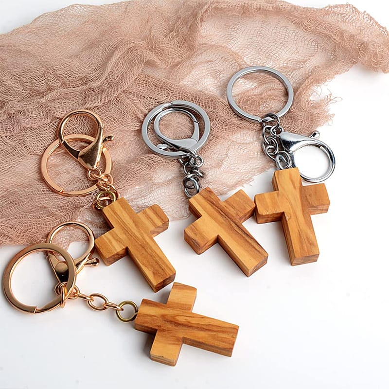 Olive wood cross keychains with gold and silver hardware. Wholesale custom wooden keychain manufacturer.