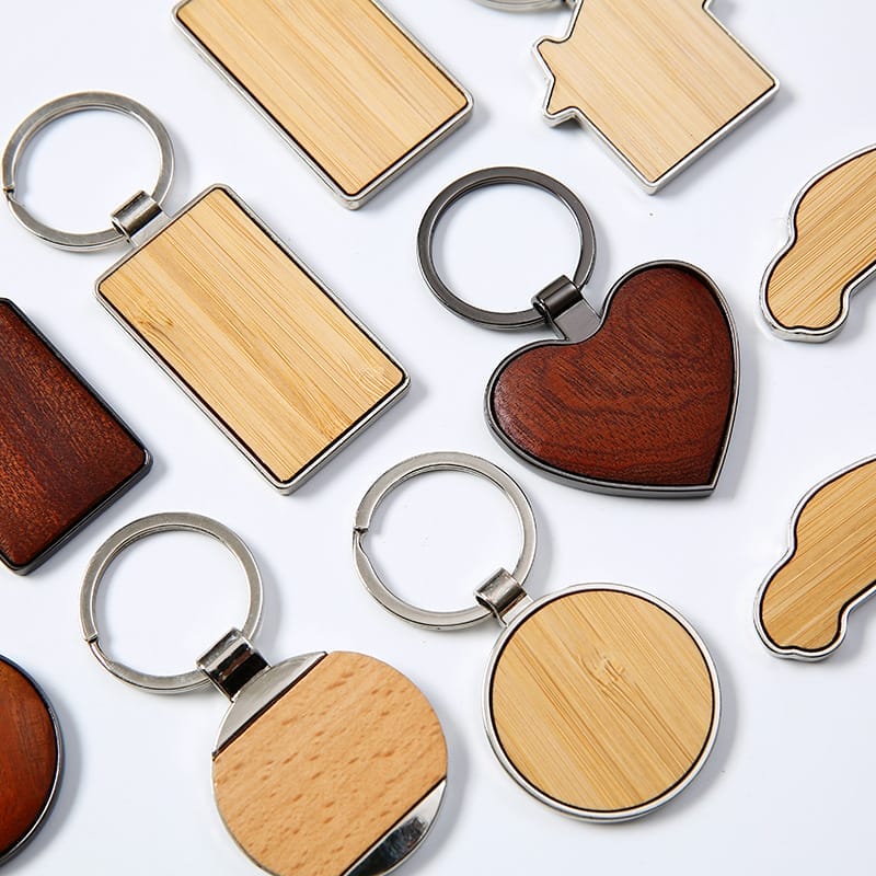 Variety of custom wooden keychains, including heart, car, and house shapes. Wholesale laser cut keychains available.