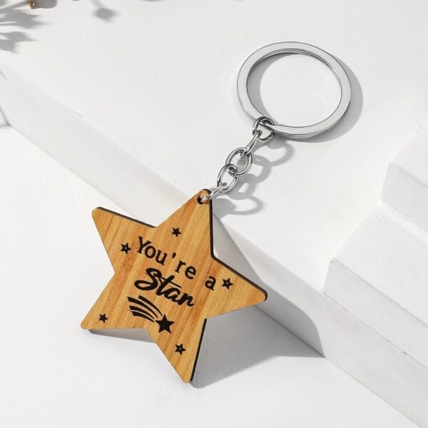 Wooden star keychain with "You're a star" engraved. Custom laser cut keychain, wholesale supplier.
