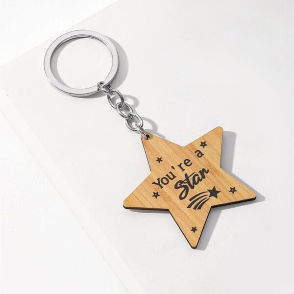 Wooden star keychain with "You're a star" engraving. Custom laser cut keychain, wholesale supplier.