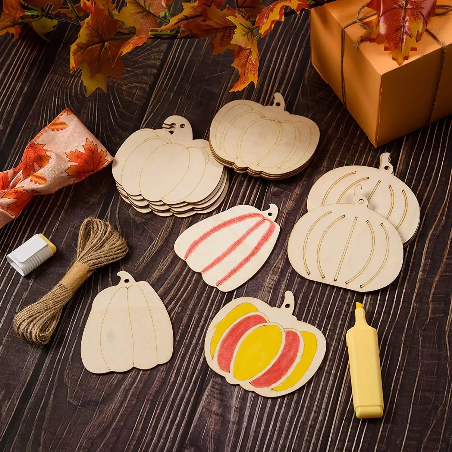 Wooden pumpkin crafts and materials for Halloween on a table