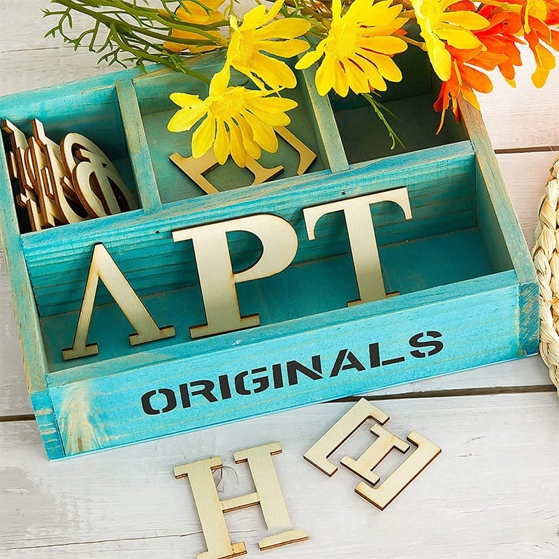 Wooden Greek alphabet letters (APT) in a teal crate. Wholesale wood craft supplies.