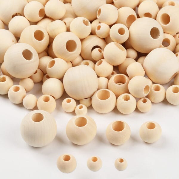 Pile of natural wooden beads for DIY jewelry making. Eco-friendly craft supplies.