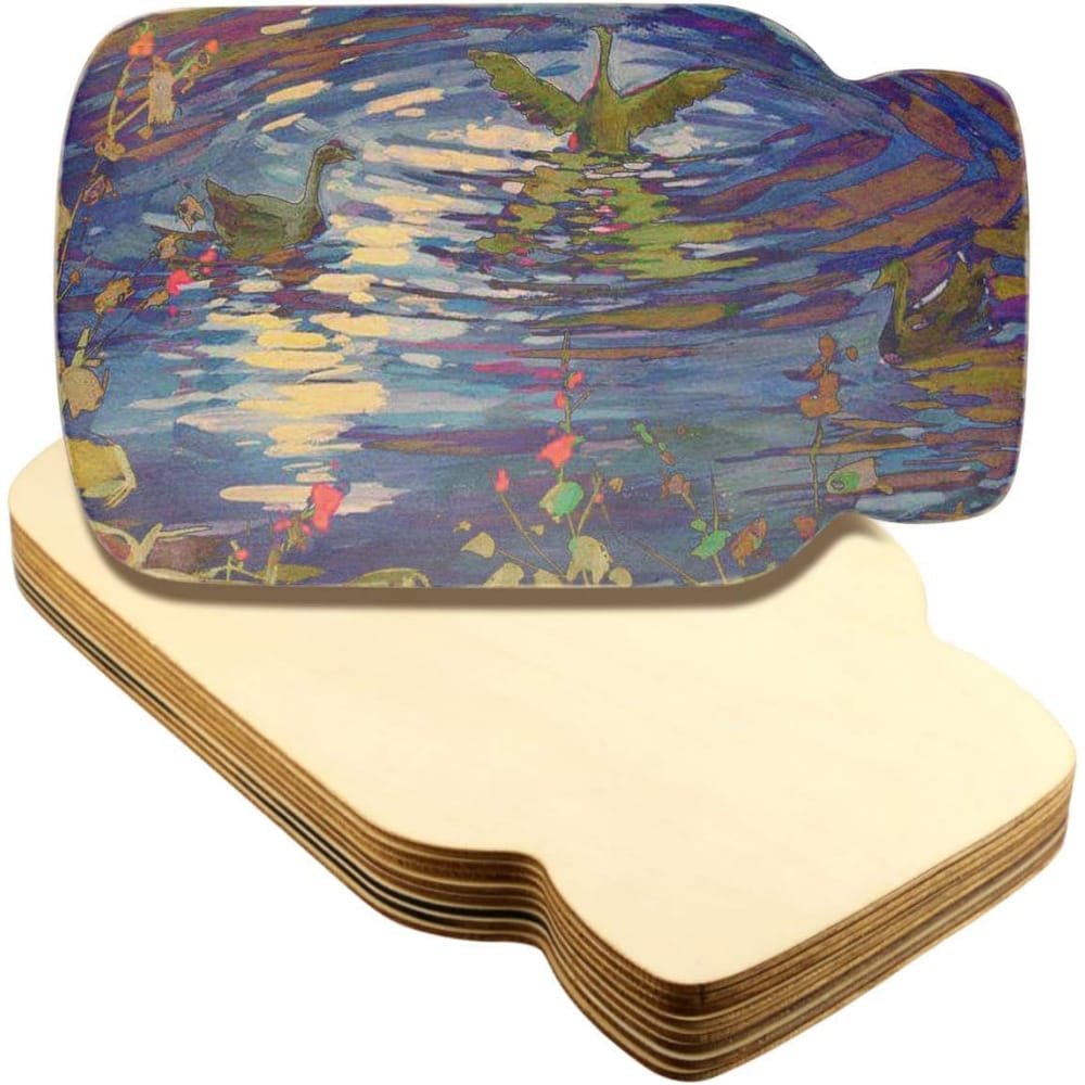 Unfinished laser cut wood cutouts, stacked, featuring a lake scene.