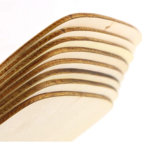 Stacked unfinished laser-cut wood blanks for home decor.