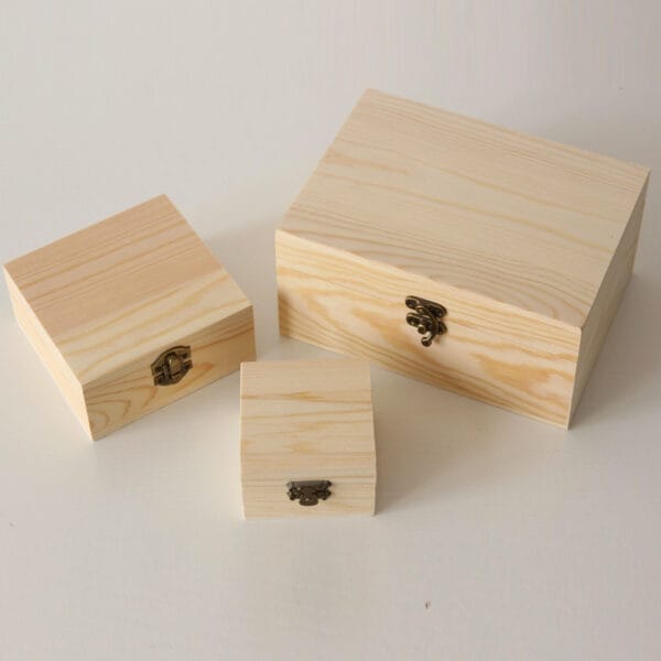 Set of three handcrafted pine lockable wooden box with brass latches; perfect for organizing and storing small items.