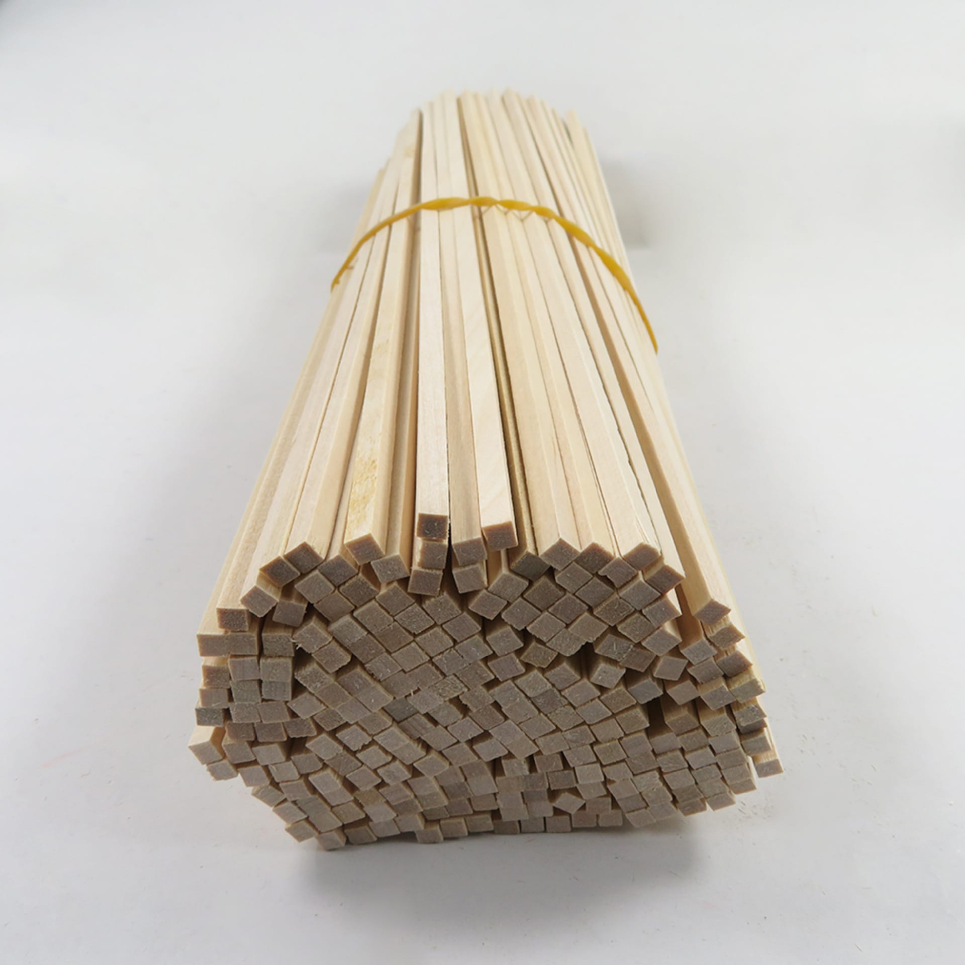 Bundle of basswood craft sticks for model building. Long wooden dowels, perfect for DIY projects.