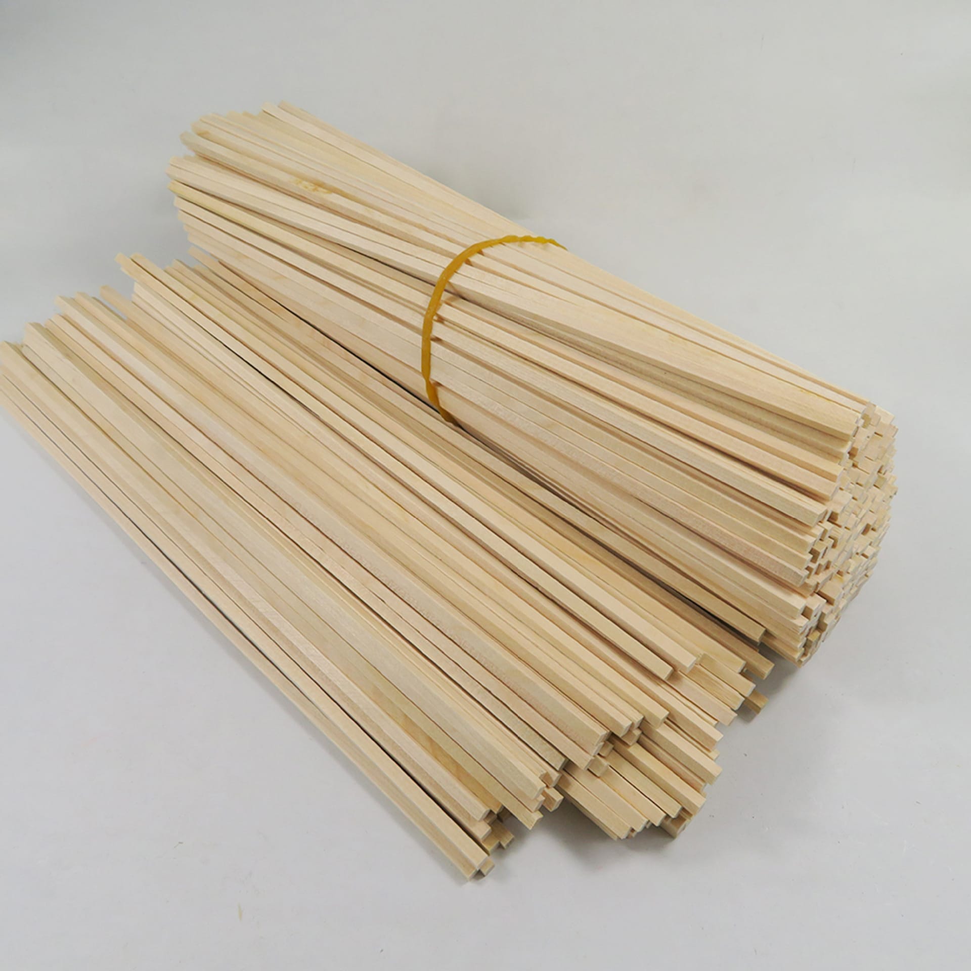 Bundle of basswood craft sticks for model building. Perfect for miniature projects and DIY crafts.