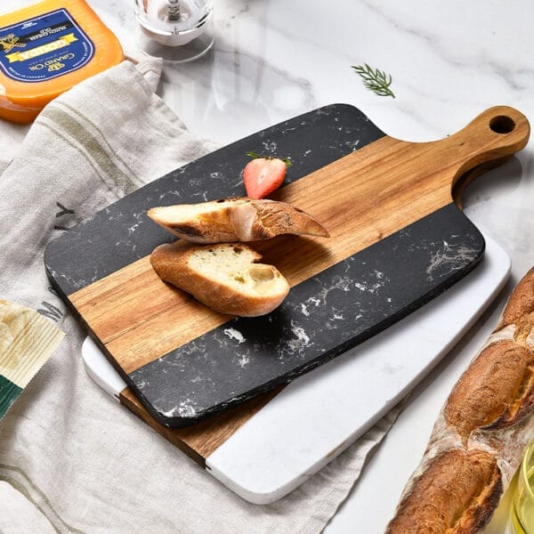 Rectangular marble and wood cutting board with bread and strawberries. Wholesale fruit board supplier.