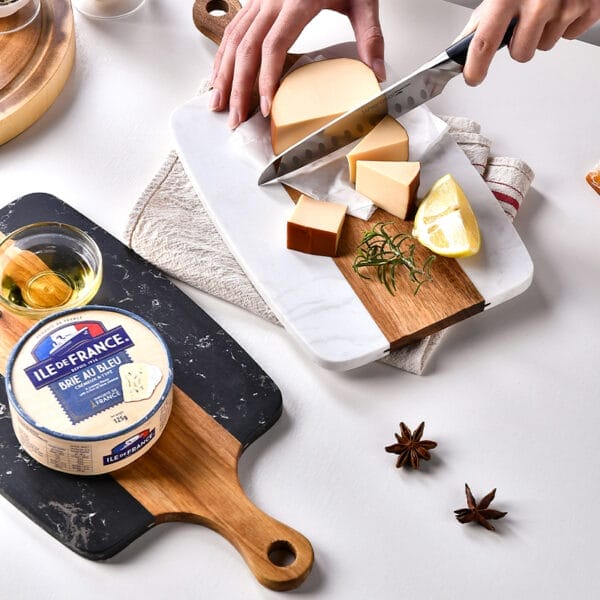 Marble and wood cheese board with brie and sliced cheese. Wholesale cutting boards.