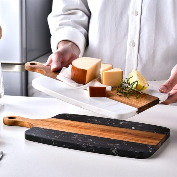 Elegant marble and acacia wood cutting board with cheese and lemon. Wholesale custom fruit boards available.
