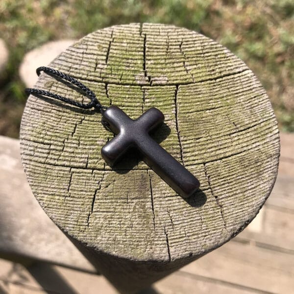 Men's eco-friendly wooden cross necklace pendant. Black wood, simple design.